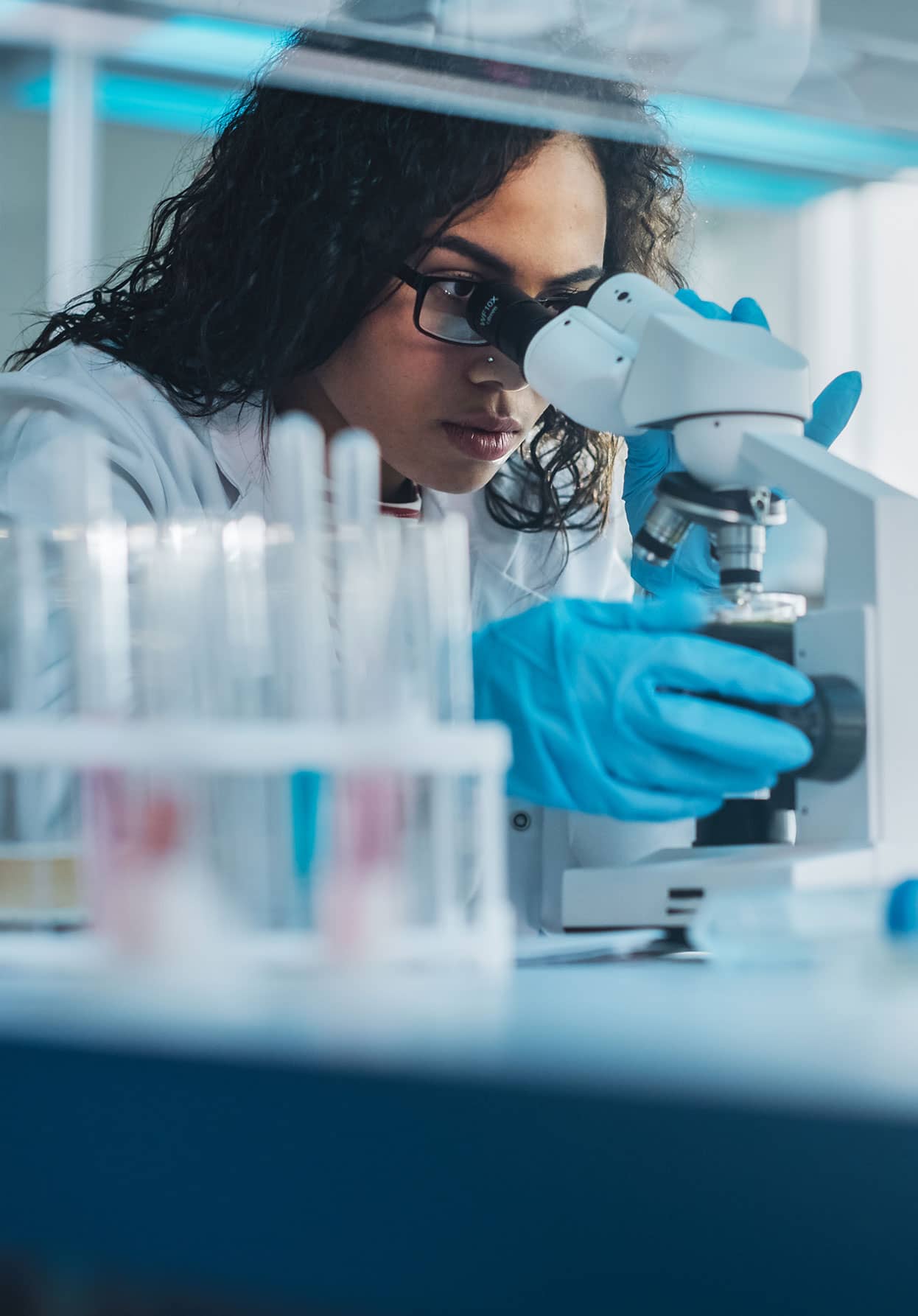 doctor looking through a microscope