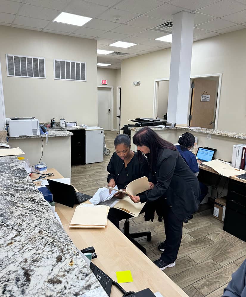 two people at a computer analyzing data